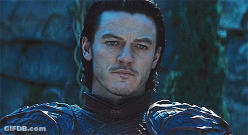 A Man With A Beard Is Wearing A Blue And Black Armor GIF