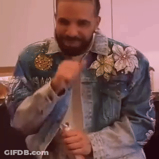 A Man With A Beard Is Wearing A Blue Denim Jacket With Flowers On The Sleeves . GIF