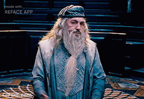 A Man With A Beard Is Wearing A Blue Hat And A Blue Coat .. GIF