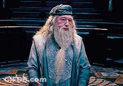 A Man With A Beard Is Wearing A Blue Hat And A Blue Coat . GIF