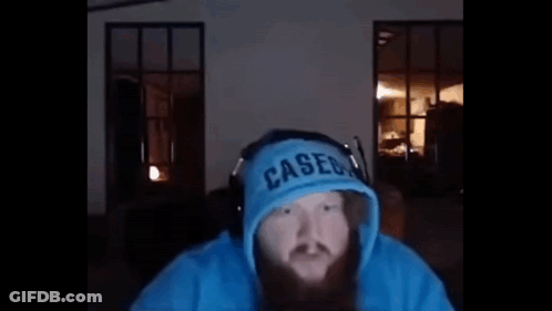 A Man With A Beard Is Wearing A Blue Hoodie And Headphones And Says `` Yo What ? '' GIF