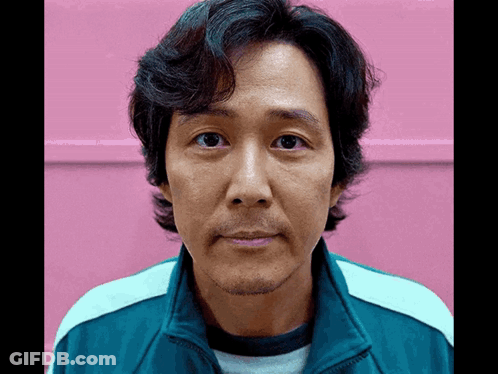 A Man With A Beard Is Wearing A Blue Jacket GIF