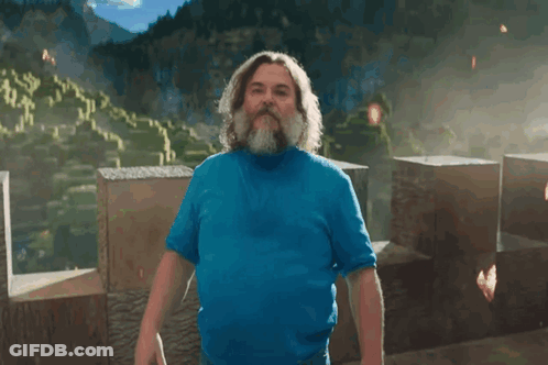 A Man With A Beard Is Wearing A Blue Shirt And Has The Letter I On His Chest GIF