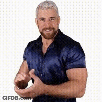 A Man With A Beard Is Wearing A Blue Shirt And Making A Funny Face . GIF