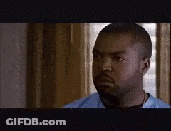 A Man With A Beard Is Wearing A Blue Shirt . GIF