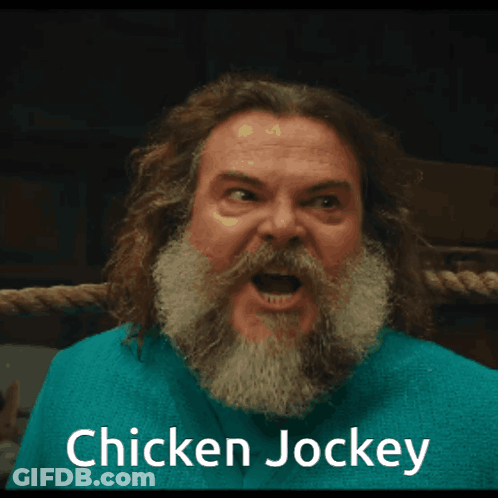 A Man With A Beard Is Wearing A Blue Shirt That Says " Chicken Jockey " GIF