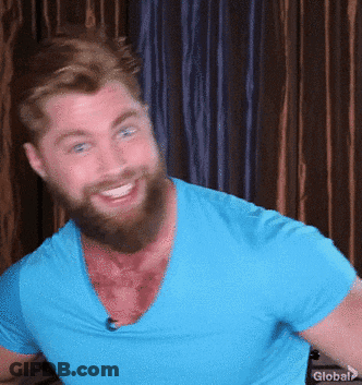 A Man With A Beard Is Wearing A Blue Shirt That Says Global On The Bottom GIF