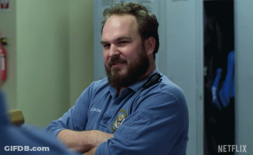 A Man With A Beard Is Wearing A Blue Shirt That Says J. Richard GIF