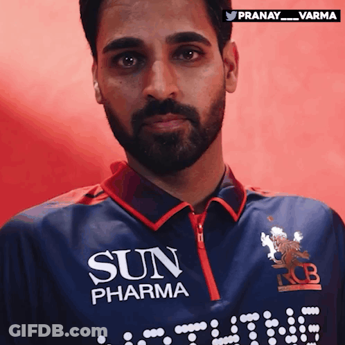 A Man With A Beard Is Wearing A Blue Shirt That Says Sun Pharma GIF