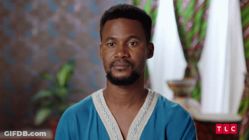 A Man With A Beard Is Wearing A Blue Shirt With The Letters Tlc On It GIF