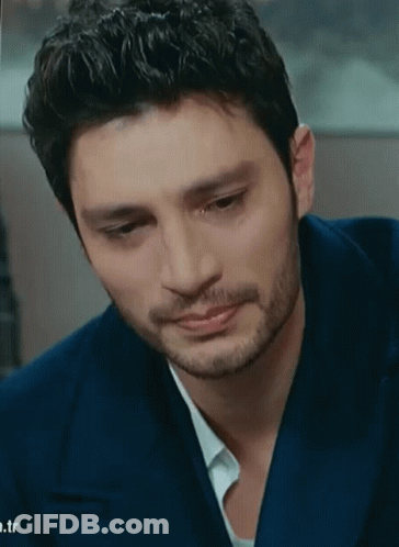 A Man With A Beard Is Wearing A Blue Suit And White Shirt GIF