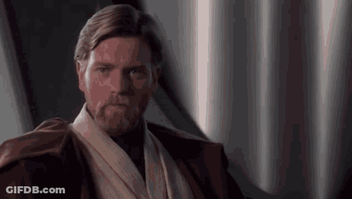 A Man With A Beard Is Wearing A Brown Jacket And A White Scarf Around His Neck . GIF