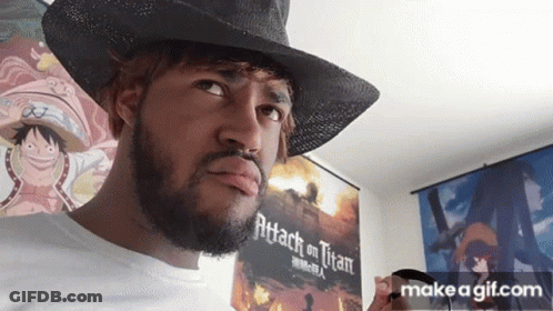 A Man With A Beard Is Wearing A Cowboy Hat And Holding A Cup In Front Of A Poster For Attack On Titan . GIF