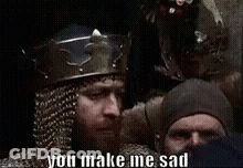 A Man With A Beard Is Wearing A Crown And A Helmet And Says You Make Me Sad . GIF