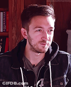 A Man With A Beard Is Wearing A Denim Jacket And A Hoodie GIF