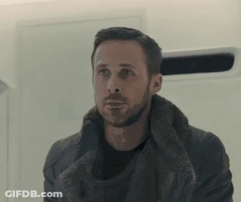 A Man With A Beard Is Wearing A Fur Coat And A Black Shirt . GIF