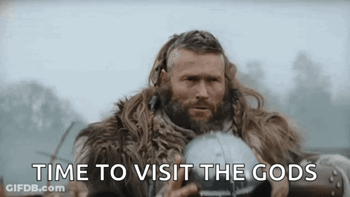 A Man With A Beard Is Wearing A Fur Coat And Holding A Helmet And Says `` Time To Visit The Gods '' . GIF
