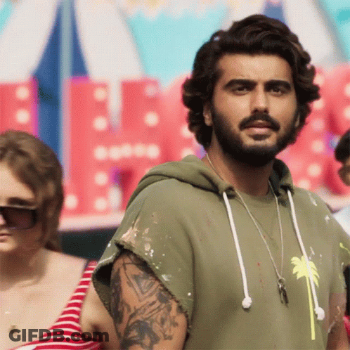 A Man With A Beard Is Wearing A Green Hoodie With A Palm Tree On It GIF