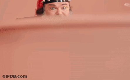 A Man With A Beard Is Wearing A Green Jacket And A Red Hat And Says Peaches Peaches GIF