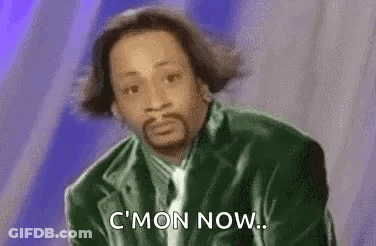 A Man With A Beard Is Wearing A Green Jacket And Tie And Is Saying `` C Mon Now '' . GIF