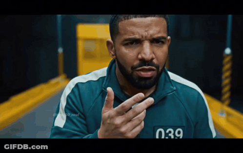 A Man With A Beard Is Wearing A Green Jacket With The Number 039 On The Front GIF