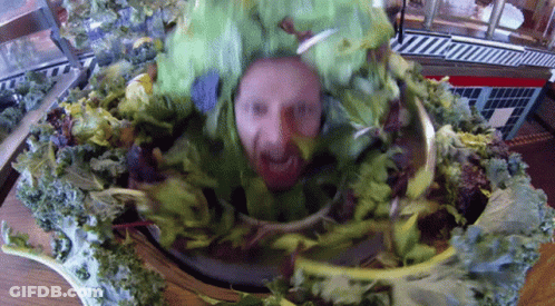 A Man With A Beard Is Wearing A Green Lettuce Costume GIF