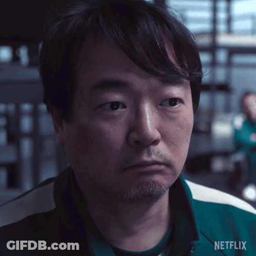 A Man With A Beard Is Wearing A Green Netflix Shirt . GIF