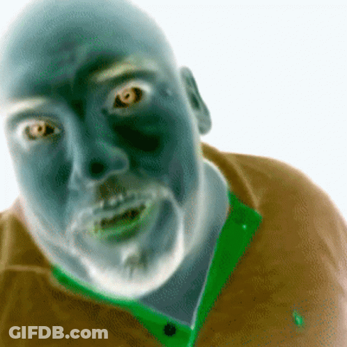 A Man With A Beard Is Wearing A Green Shirt GIF