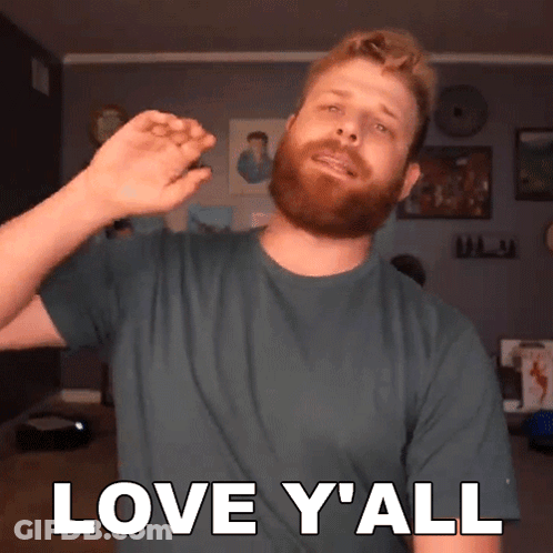 A Man With A Beard Is Wearing A Green Shirt That Says Love Y All GIF