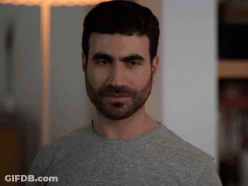 A Man With A Beard Is Wearing A Grey T-Shirt GIF
