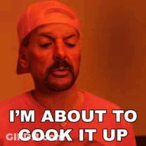 A Man With A Beard Is Wearing A Hat And A Red Shirt And Says I 'M About To Cook It Up GIF