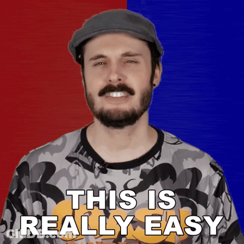 A Man With A Beard Is Wearing A Hat And A Shirt That Says This Is Really Easy GIF