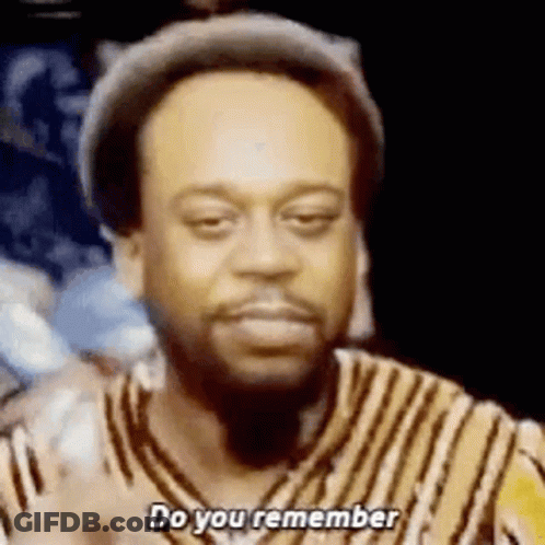 A Man With A Beard Is Wearing A Hat And A Striped Shirt And Is Asking Do You Remember . GIF