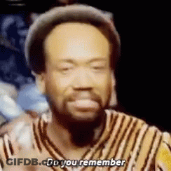 A Man With A Beard Is Wearing A Hat And A Striped Shirt And Saying `` Do You Remember '' . GIF