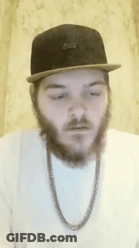 A Man With A Beard Is Wearing A Hat And Chain GIF