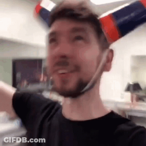 A Man With A Beard Is Wearing A Hat Made Out Of A Bottle . GIF