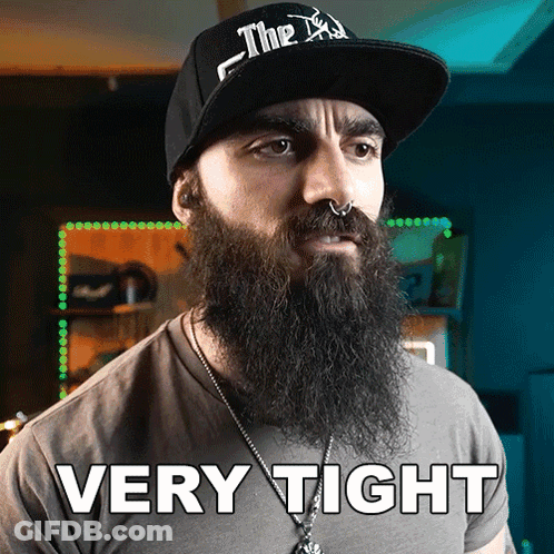 A Man With A Beard Is Wearing A Hat That Says Very Tight On It GIF