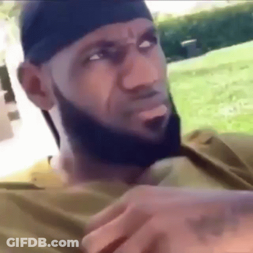 A Man With A Beard Is Wearing A Headband And A Bandana . GIF