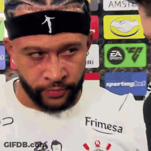 A Man With A Beard Is Wearing A Headband And A Shirt That Says Frimesa GIF