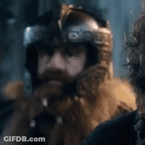 A Man With A Beard Is Wearing A Helmet And A Fur Hood . GIF