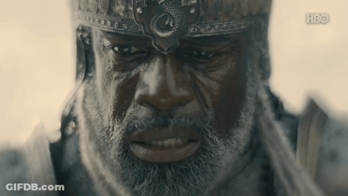 A Man With A Beard Is Wearing A Helmet With A Dragon On It GIF