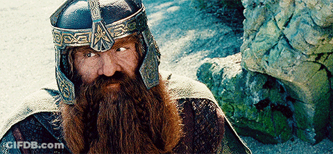 A Man With A Beard Is Wearing A Helmet With The Letter X On It GIF