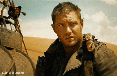 A Man With A Beard Is Wearing A Jacket That Says ' G ' On It GIF