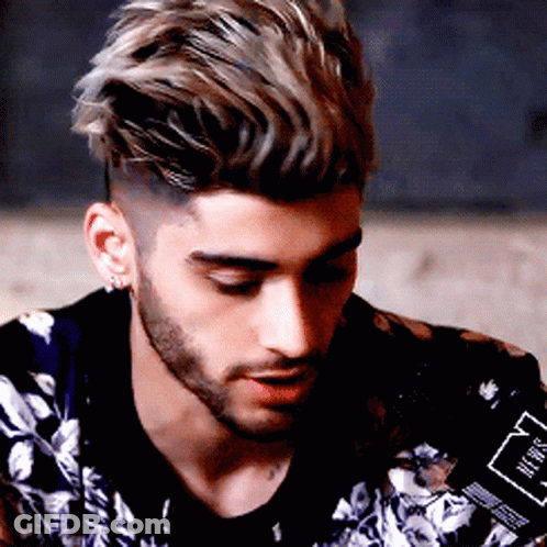 A Man With A Beard Is Wearing A Jacket With A Floral Pattern GIF