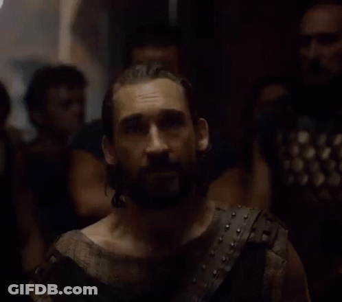 A Man With A Beard Is Wearing A Leather Vest GIF