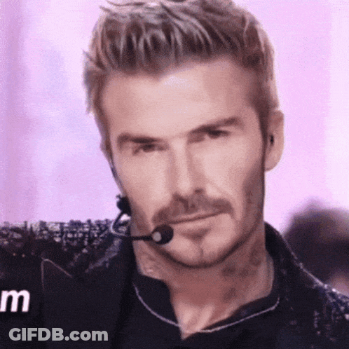 A Man With A Beard Is Wearing A Microphone And Headphones . GIF