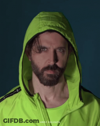 A Man With A Beard Is Wearing A Neon Green Jacket With The Word Kolkata On It GIF