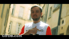 A Man With A Beard Is Wearing A Nike Shirt And Pointing To His Chest GIF