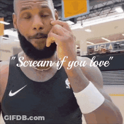 A Man With A Beard Is Wearing A Nike Tank Top And Wristband . GIF