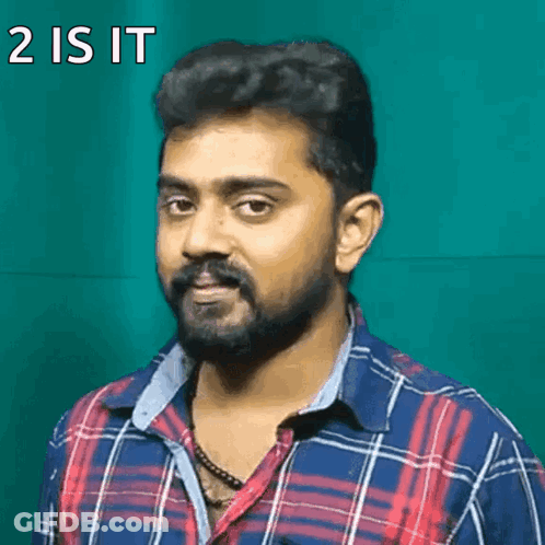 A Man With A Beard Is Wearing A Plaid Shirt And Has The Words 2 Is It On His Face GIF
